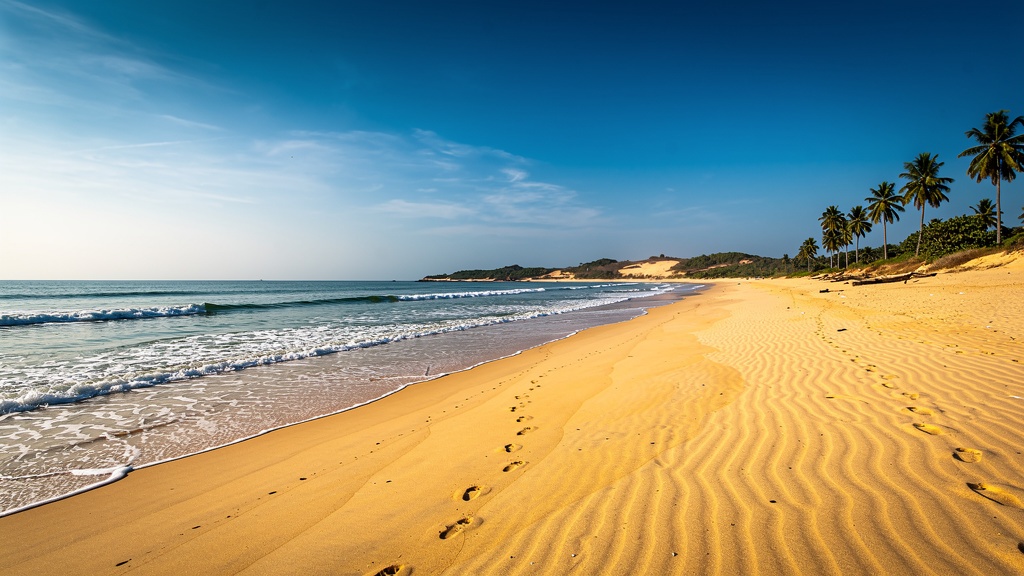 Long clean golden sandy beach of Ghoghla stretching to the horizon