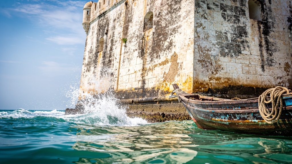 Walls of the sea fort with waves breaking at the base